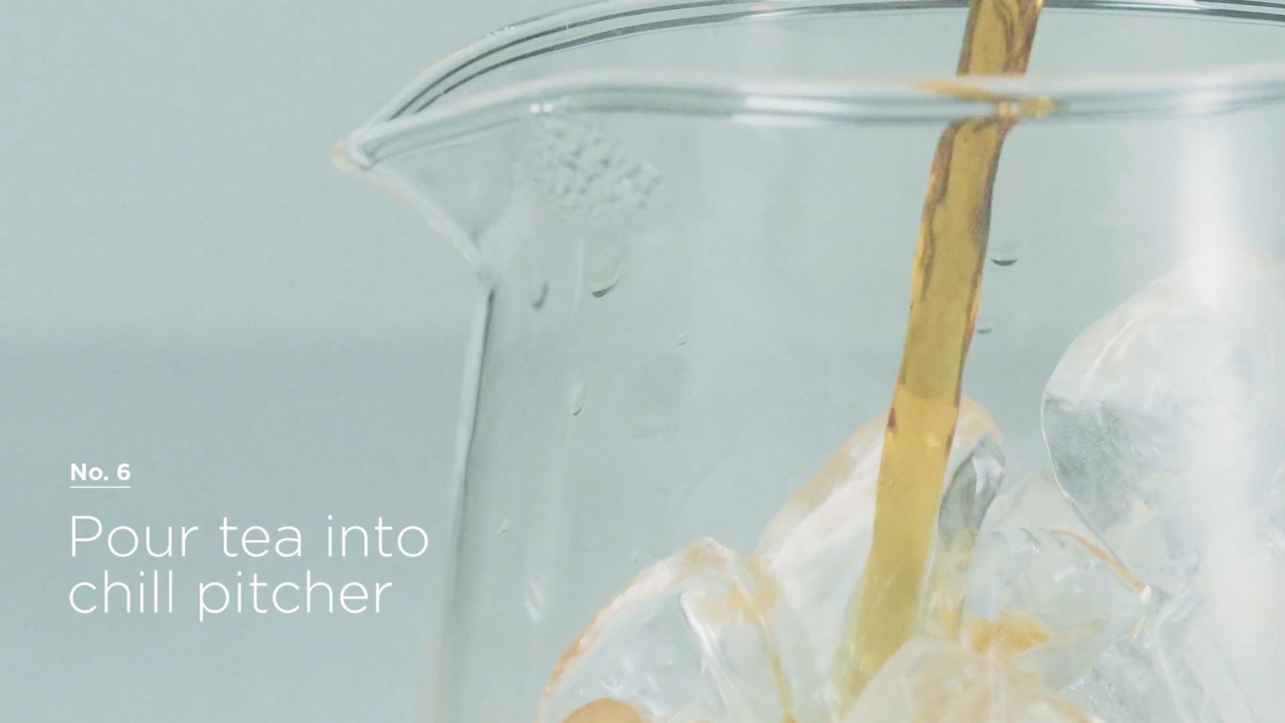 Step 6: Pouring the the hot tea from the small steeping pitcher into the large ice-filled pitcher.