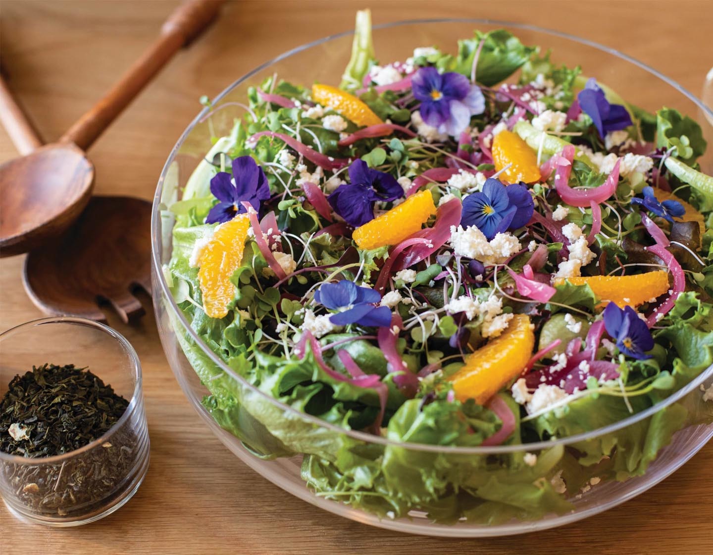 A large salad bowl dressed with Wildflower Honey Citrus Vinaigrette
