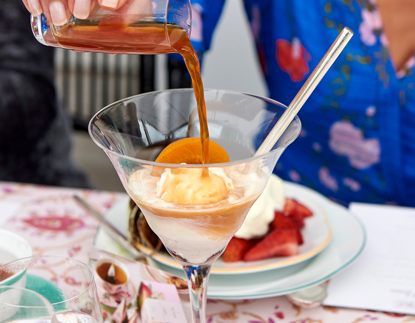 Pouring the topper into a martini glass with Apricot Amaretto Affogato