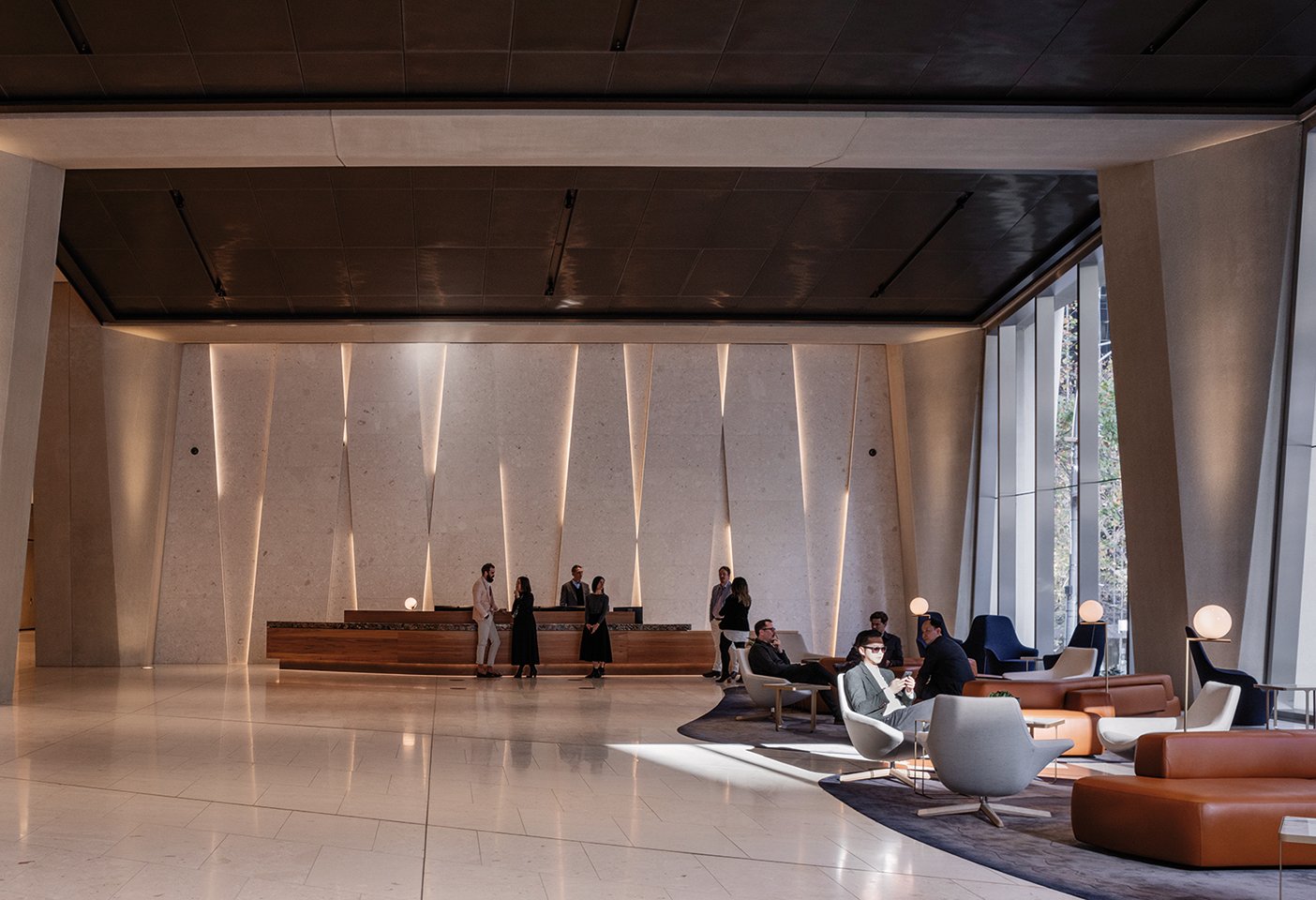 The commercial tower lobby with its expressive concrete form, and furniture by B&B Italia including the Harbor and Metropolitan armchairs. Photography © Trevor Mein.  