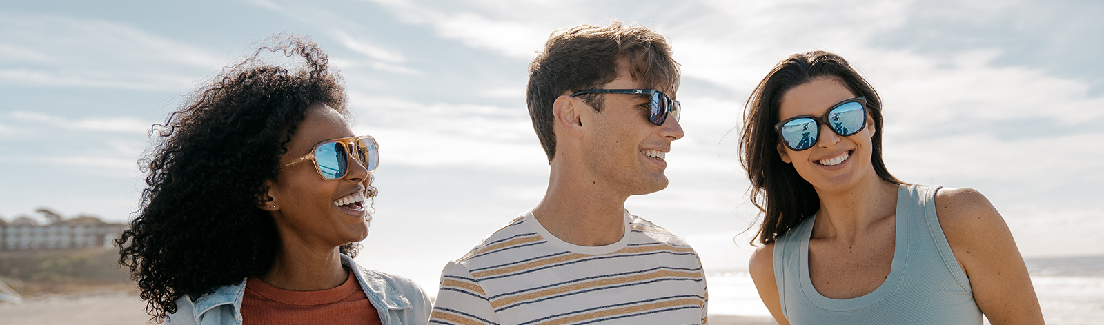Guy and girl wearing Knockaround sunglasses at the beach