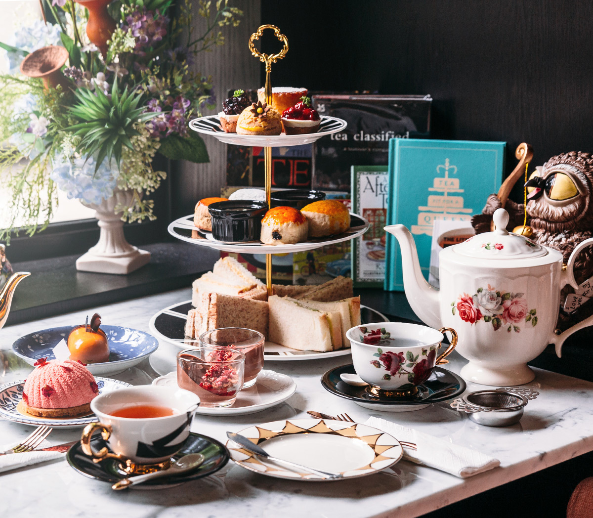 Bed & Breakfast table filled with snack sandwiches, teapots, teacups and fruit