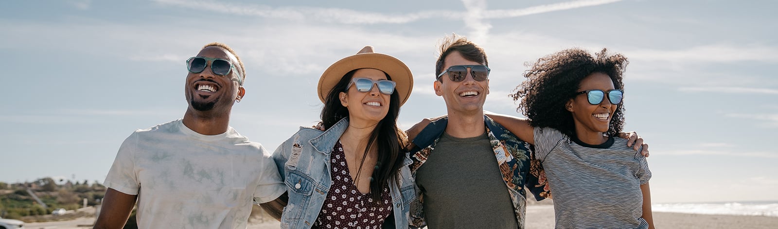 Group of friends wearing Knockaround sunglasses at the beach