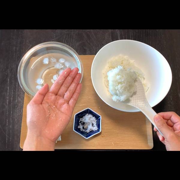 Adding Portion of Warmed Rice to Hand