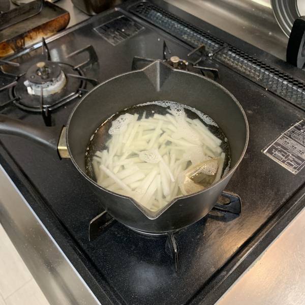 daikon and dashi packet in the pot 