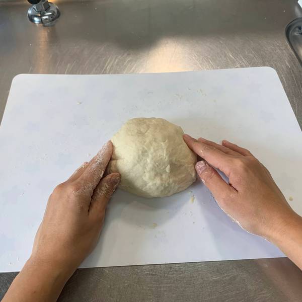 Kneading the dough back into a circle 