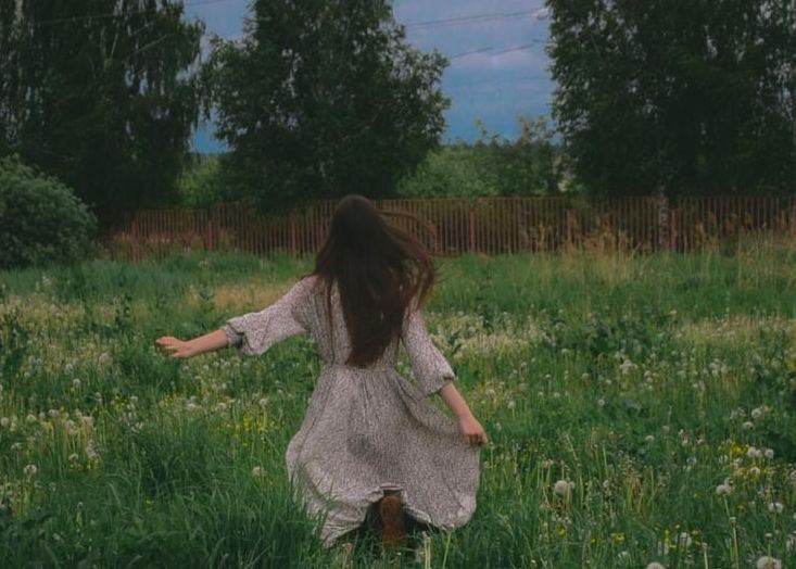 Girl running through the fields