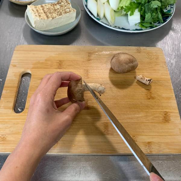 Removing the stem of a shiitake mushroom