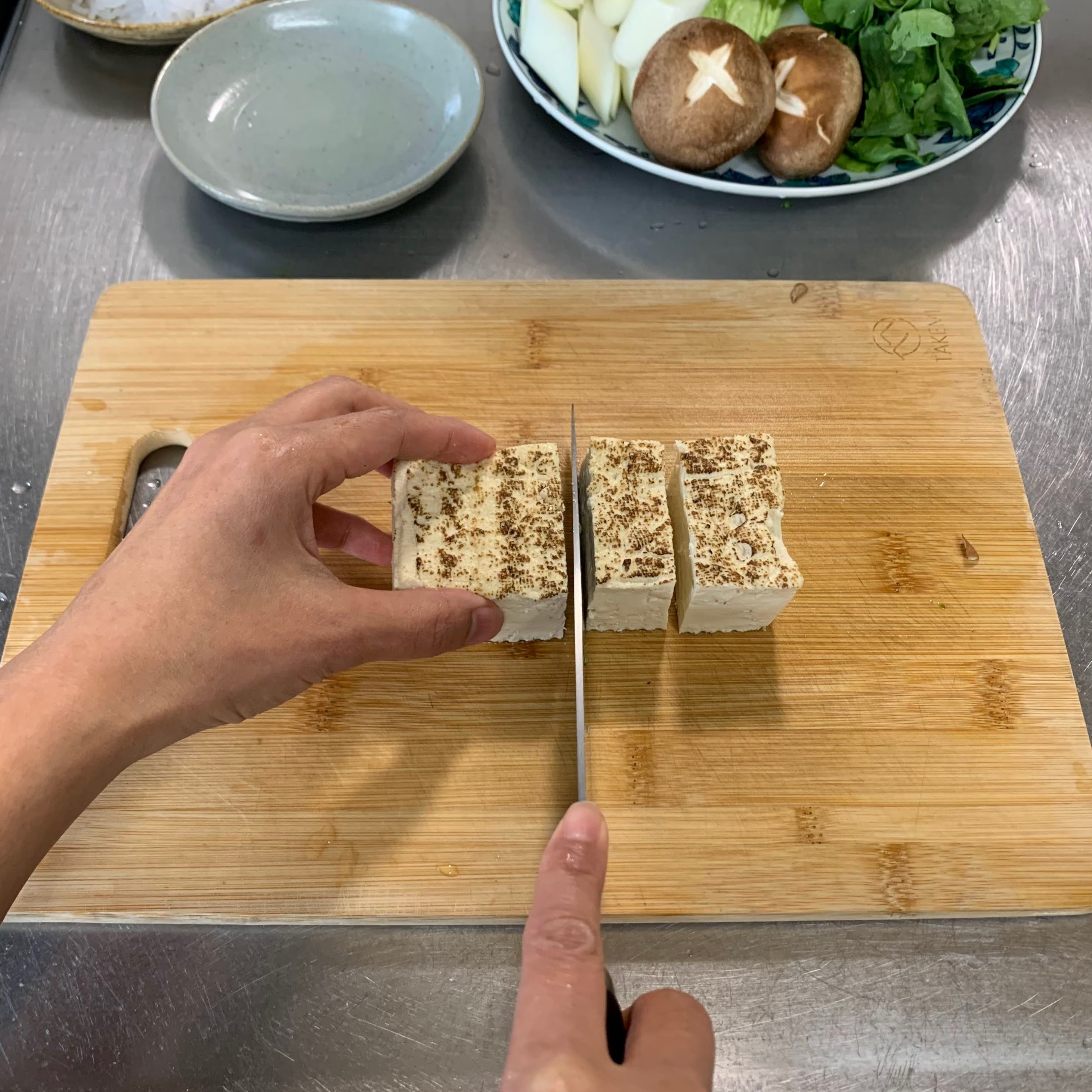 Cutting tofu into bite-sized pieces 