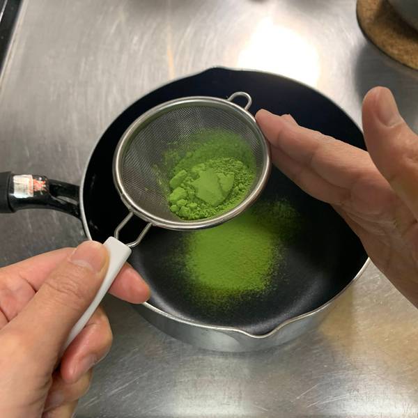 Sifting the matcha powder into the saucepan 