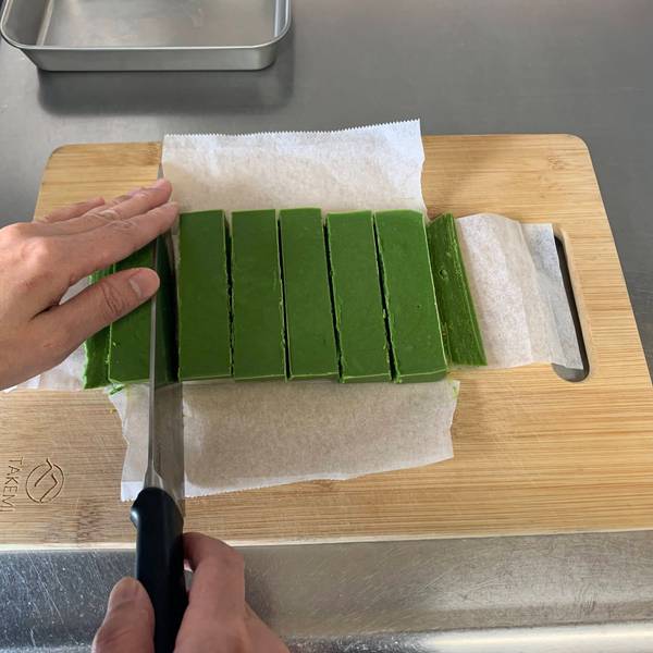 Chopping the matcha nama chocolate into smaller square-shaped pieces