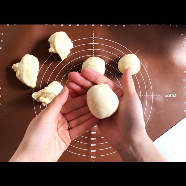 Rolling each piece of dough into a smooth ball