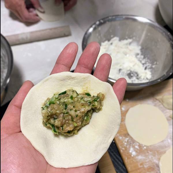 Placing gyoza wrapper inside of the filling