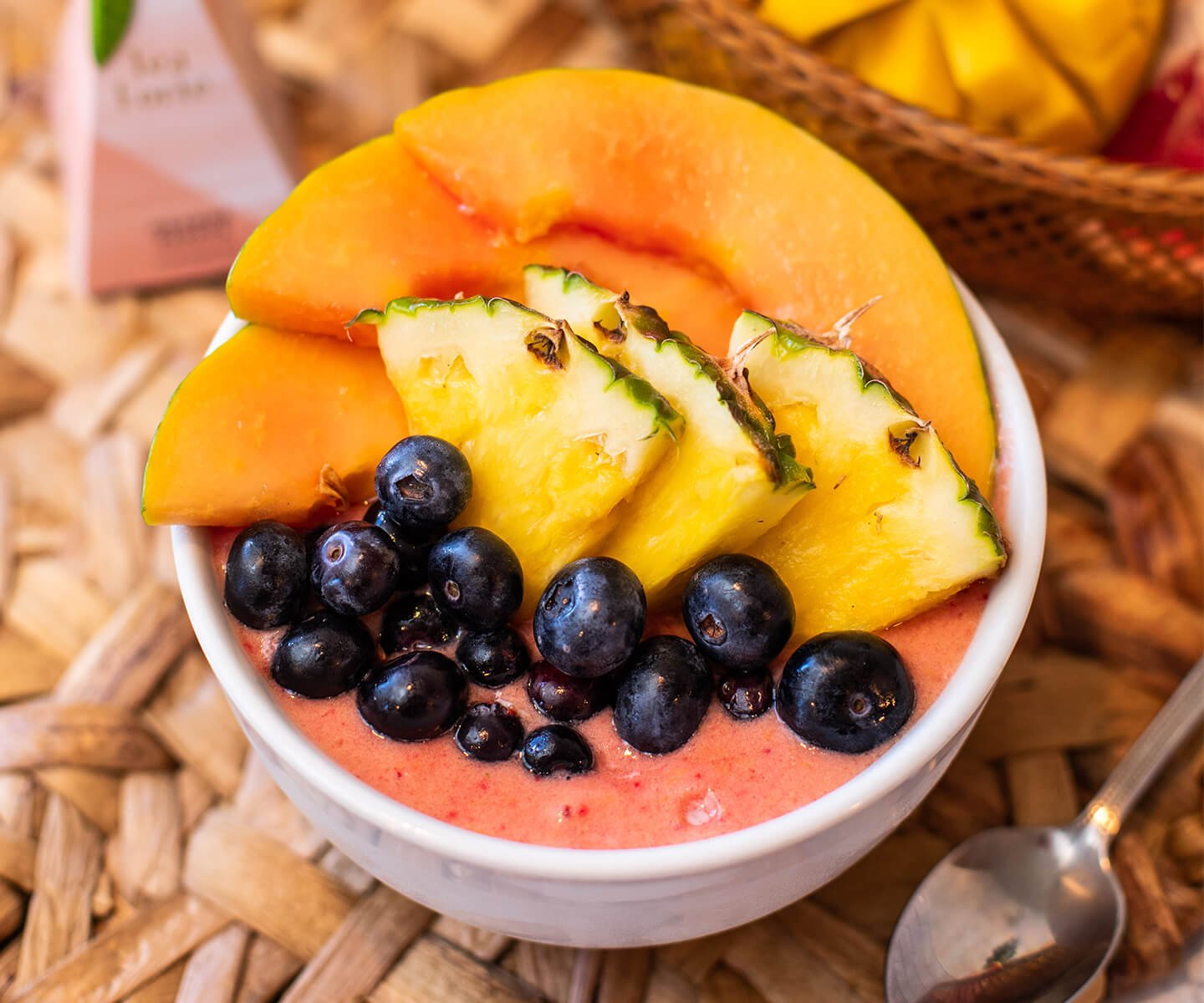 Orange Papaya Smoothie Bowl from above, with spoon