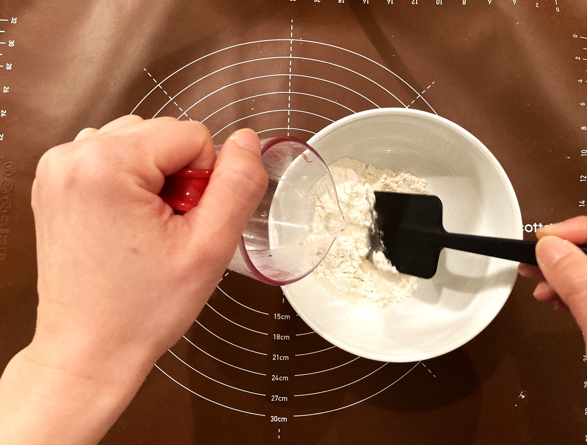 Adding the hot water to the flour 