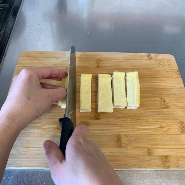 Chopping the fried tofu into strips