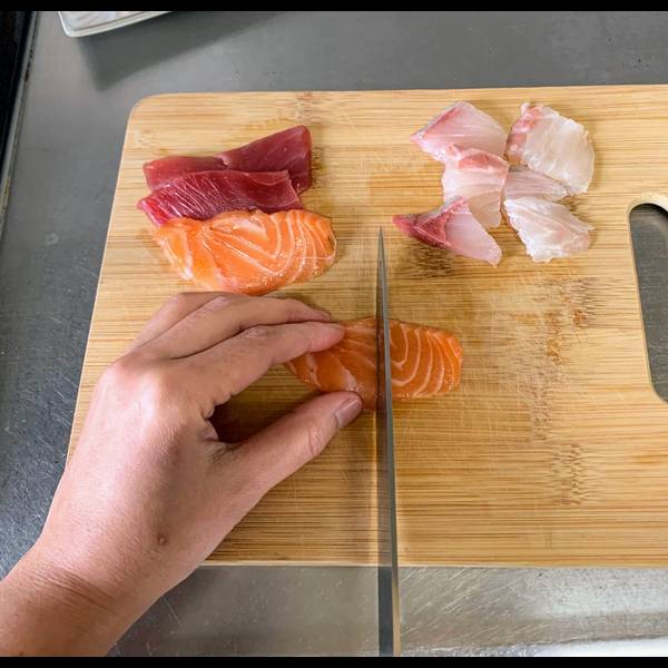 Cutting sashimi into smaller pieces