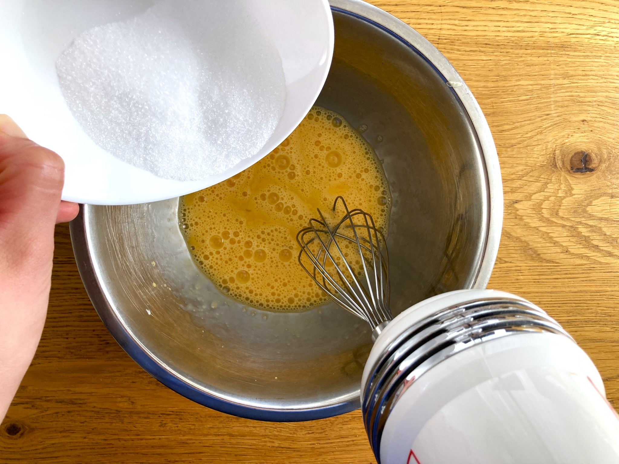 Adding the sugar to the eggs before mixing