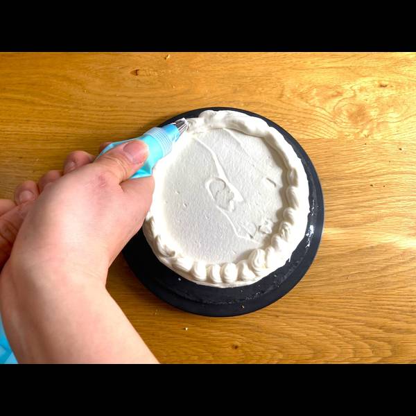 Adding decorative frosting using a piping bag