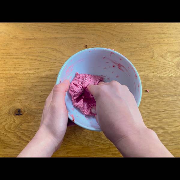 Combining ingredients of pink dango together with hands