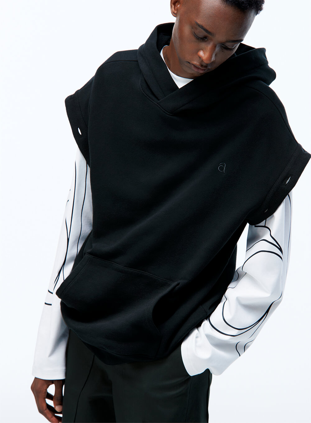 model wearing a hooded sweatshirt over a long sleeve tee