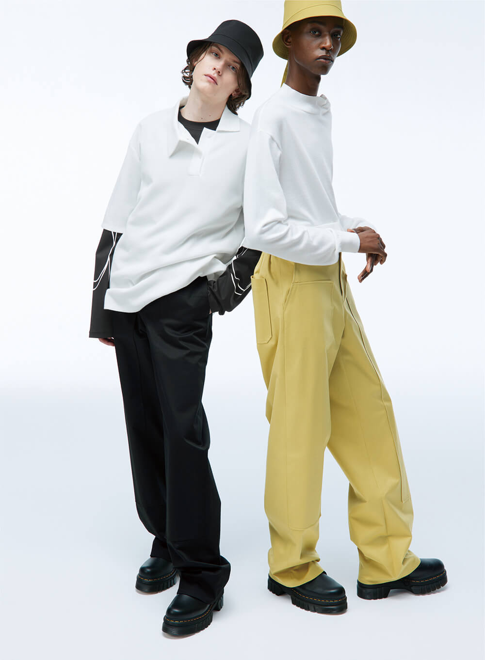 two models in unisex pants and oversized shirts