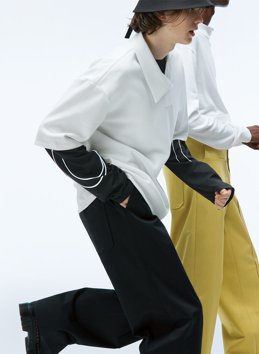 two models in motion in unisex pants and oversized shirts