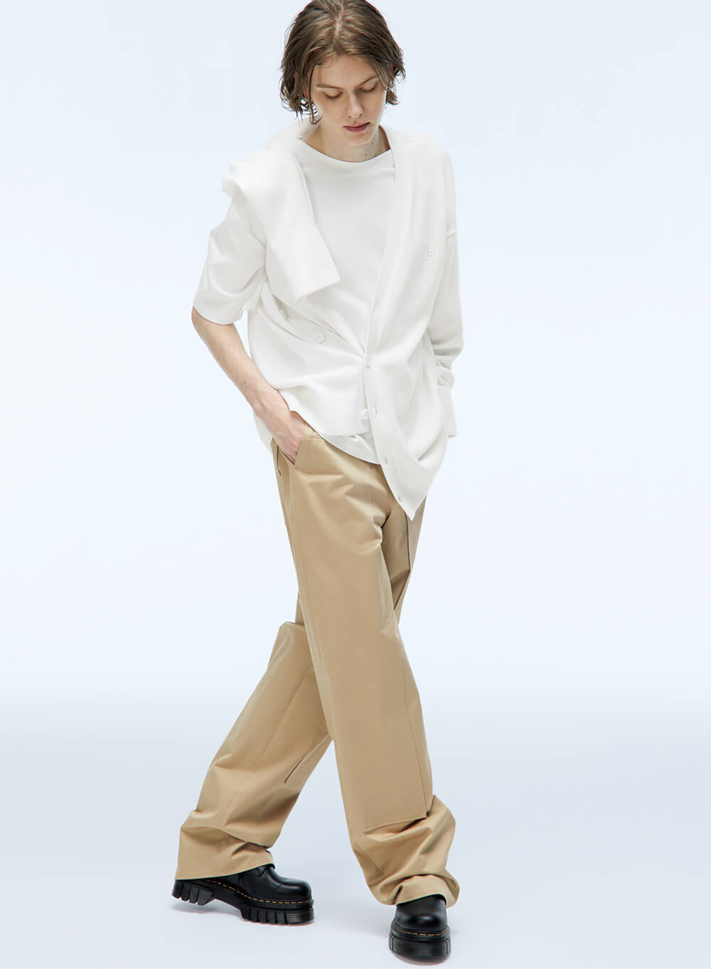model wearing oversized unisex button down shirt and khakis
