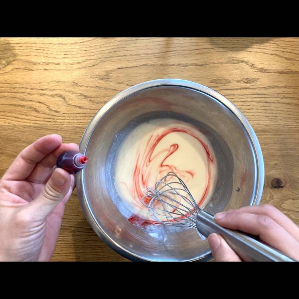 Adding red food coloring into the dough
