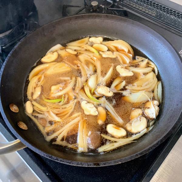 Adding the onions and the shiitake mushrooms