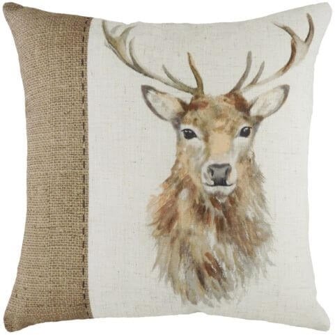 A neutral cushion with a hand-painted watercolour design of a stag's head, complete with a printed hessian-effect strip.