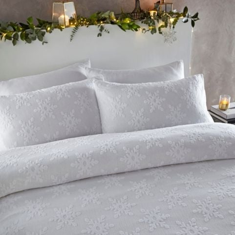 A modern Christmas bedding set with a tufted design of snowflakes in an all-white colourway.