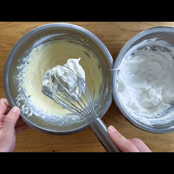 Adding the egg whites into the cheesecake batter