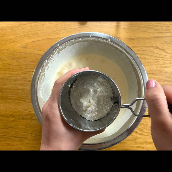 Adding flour into the eggs