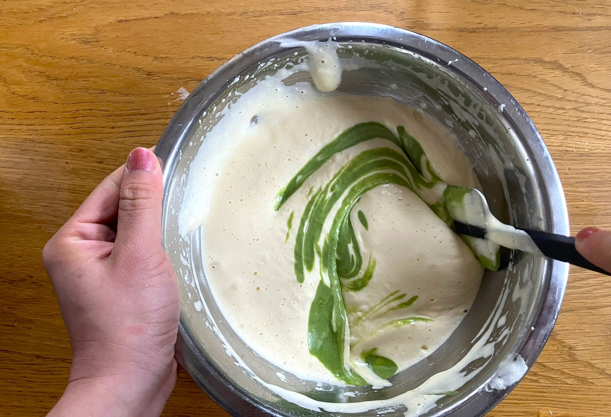 Mixing the matcha batter into the egg batter