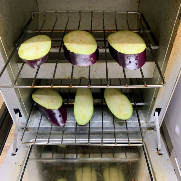 Adding eggplant slices to the toaster oven
