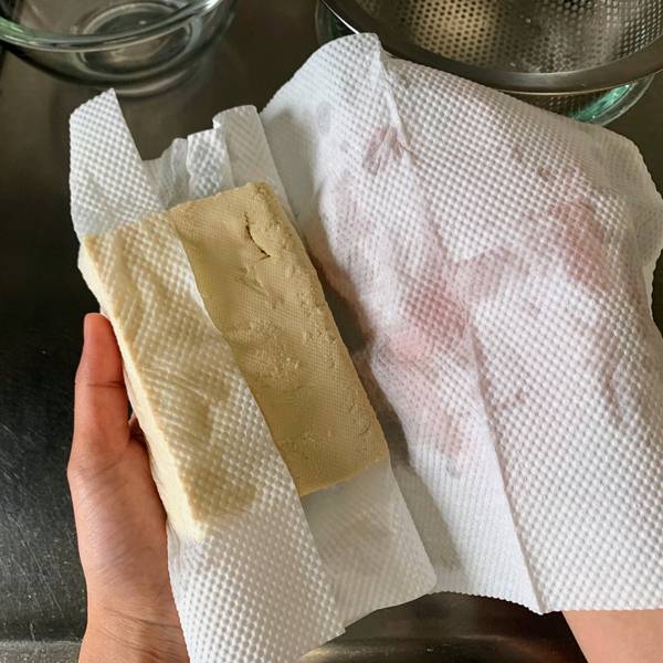 Wrapping the tofu in paper towel
