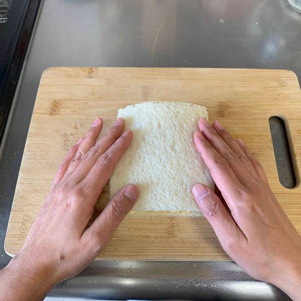Placing the other piece of bread on top