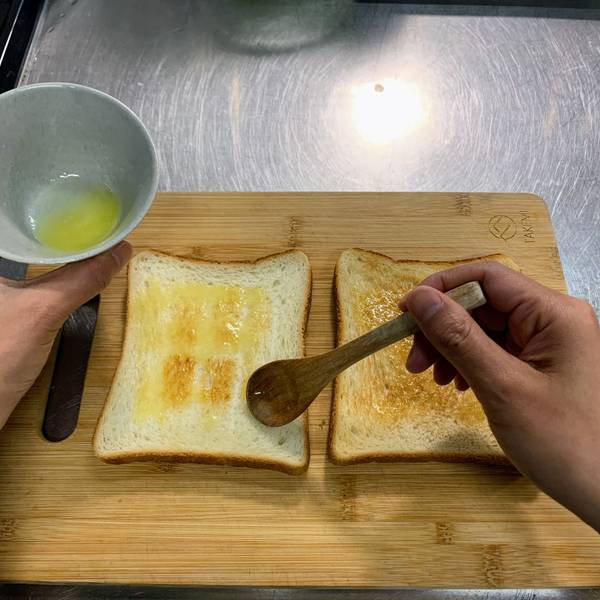 Buttering the toasted shokupan