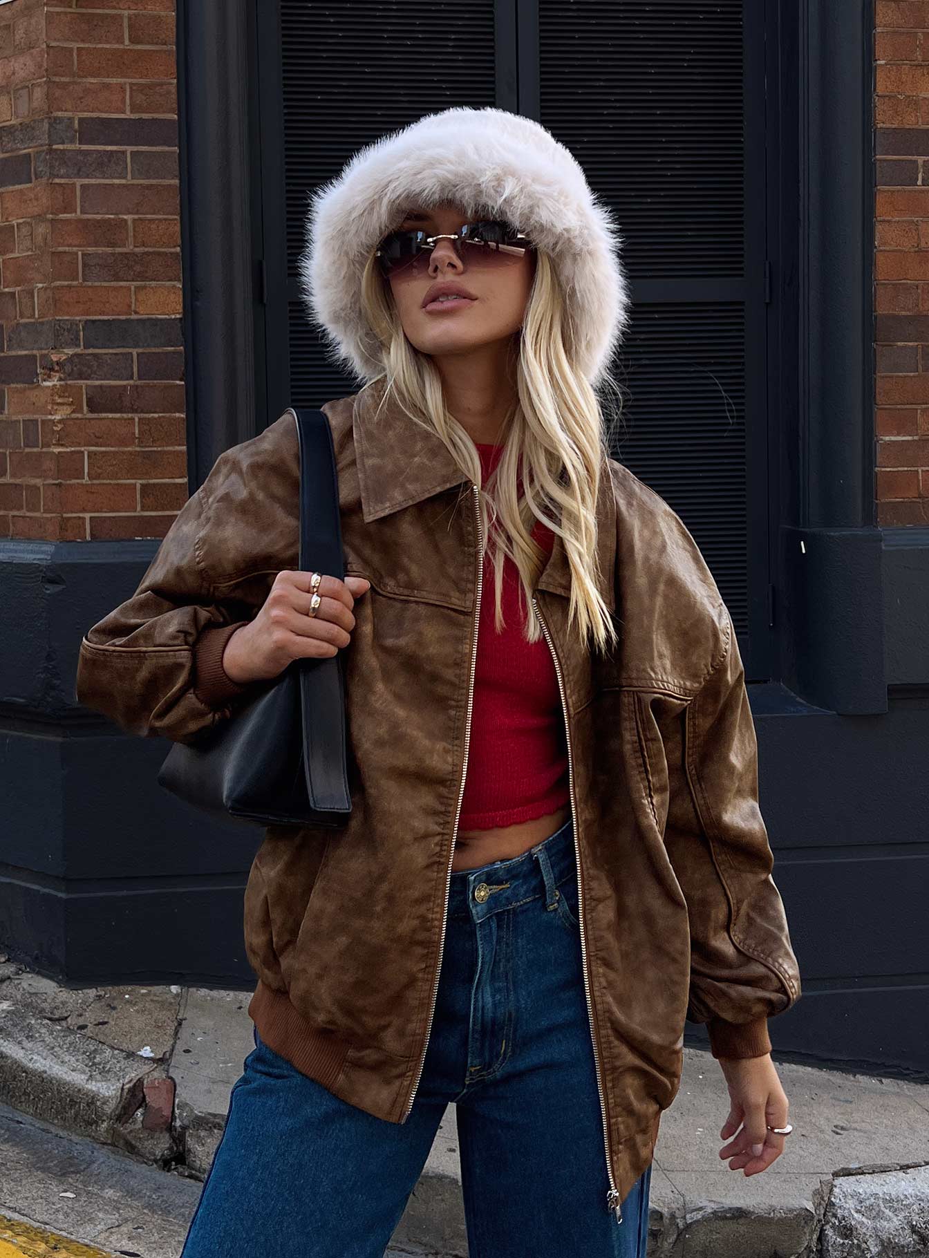 woman wearing brown faux leather bomber jacket