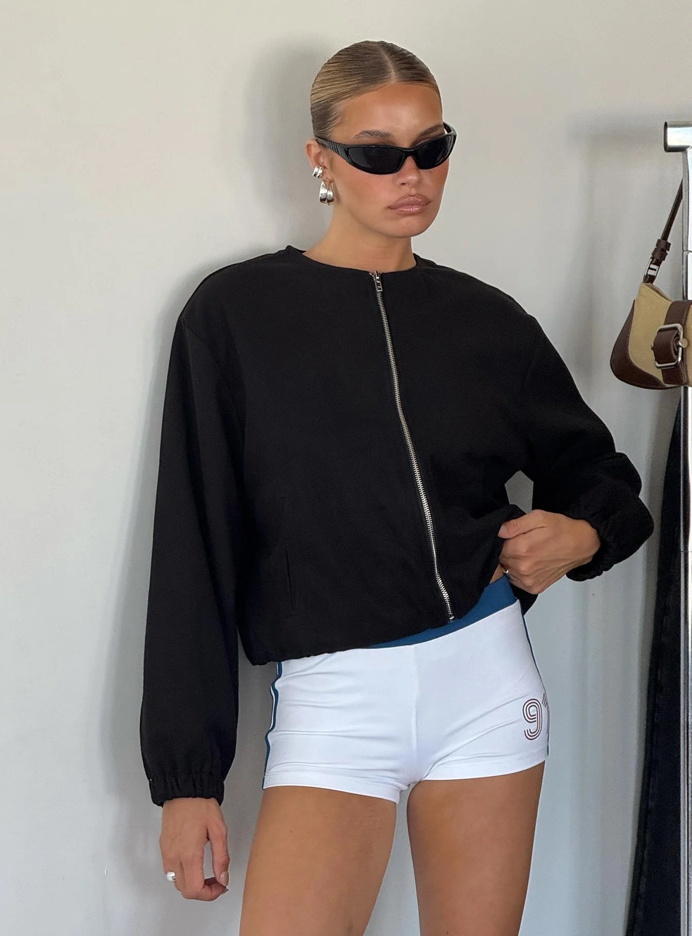 woman wearing princess polly black bomber jacket