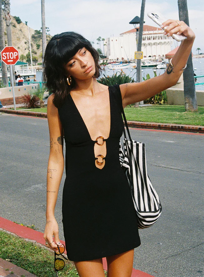 woman wearing black mini dress in europe