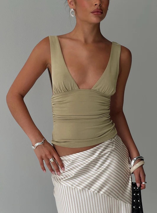 woman wearing green ruched top in europe