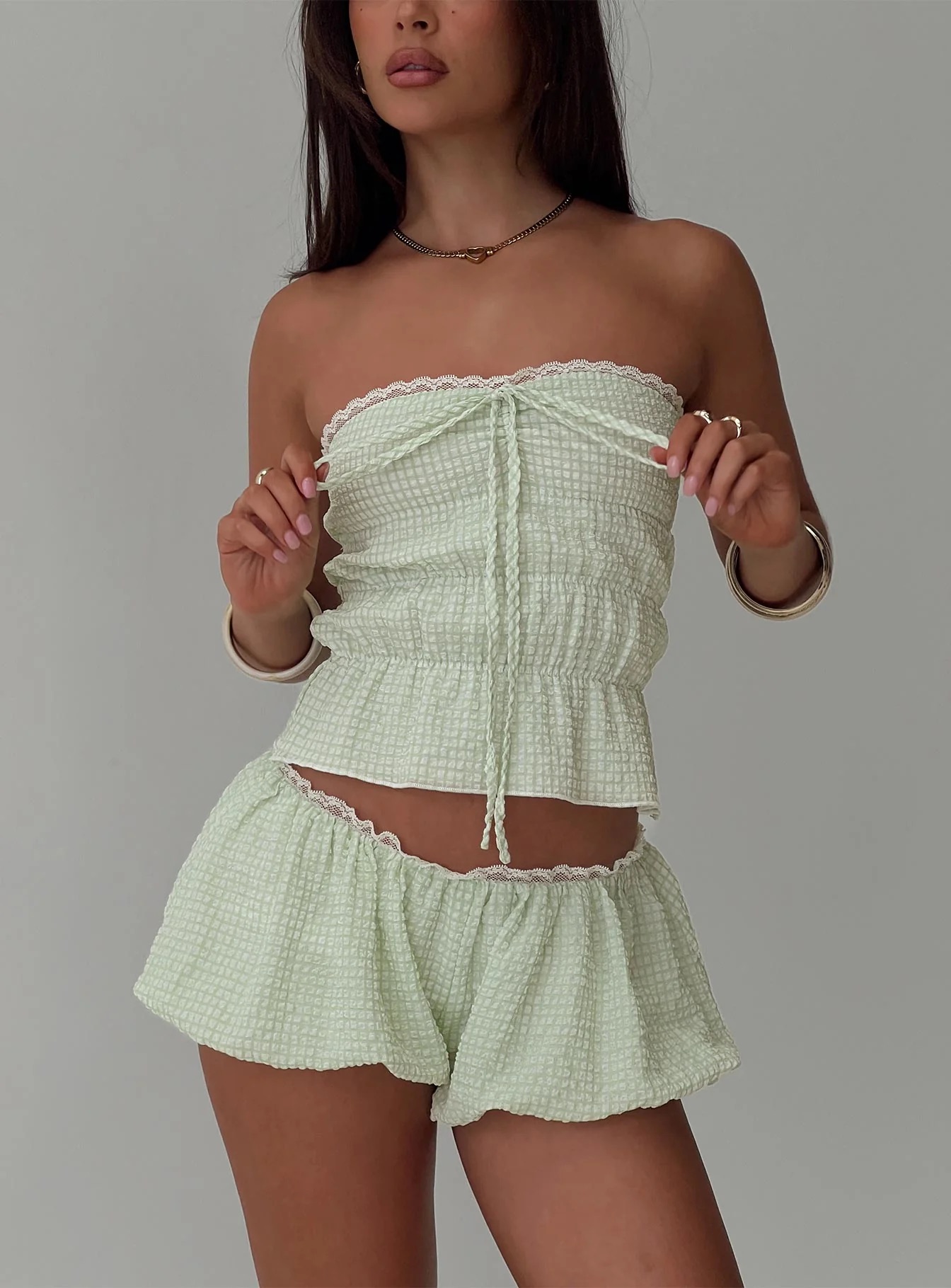 woman wearing green check strapless top and shorts in europe