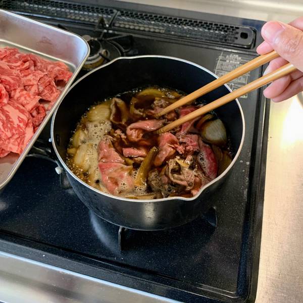 Adding the beef to the simmering sauce