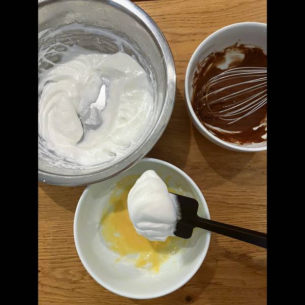 Splitting the egg white mixture evenly among both pancake batters