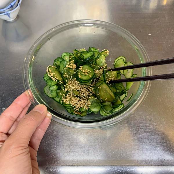 Mixing the seasonings into the cucumbers