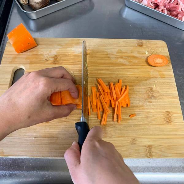 Slicing the carrots into matchsticks
