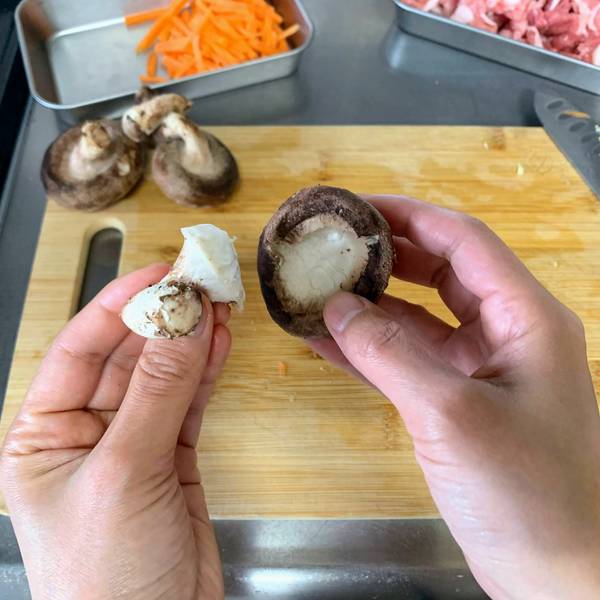Removing the stem from the shiitake mushrooms
