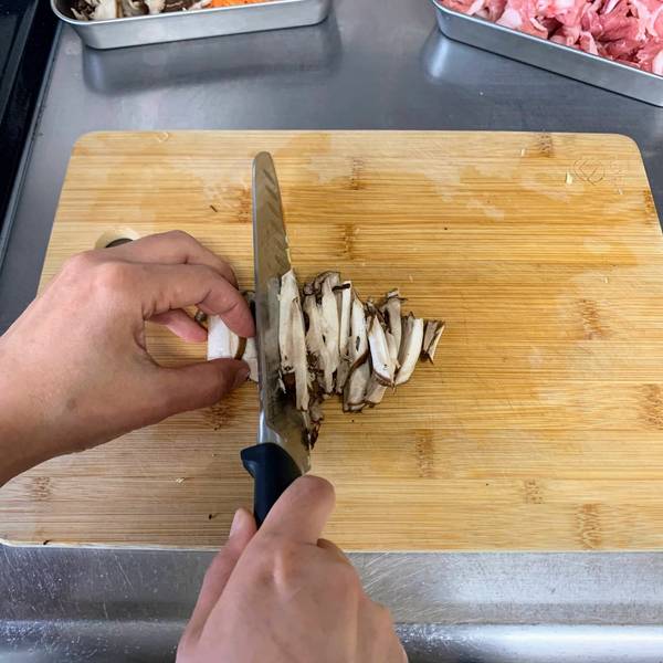 Slicing the shiitake mushrooms